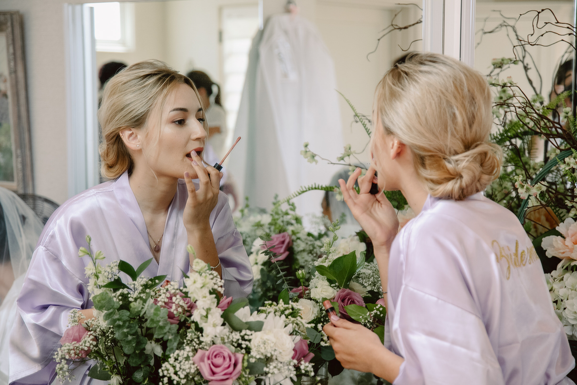 Bridal party putting on makeup