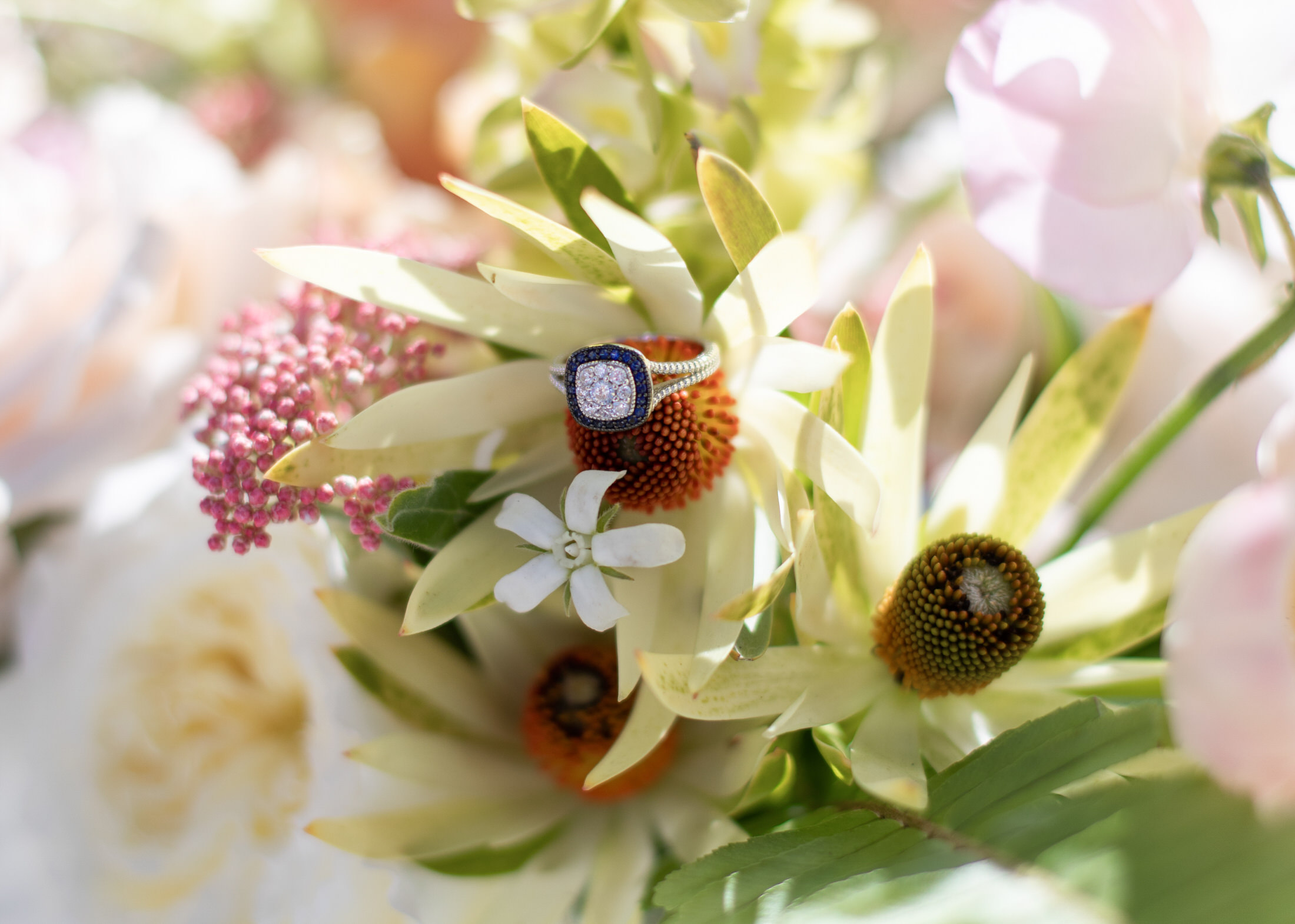 Wedding ring details in tropical bridal bouquet.