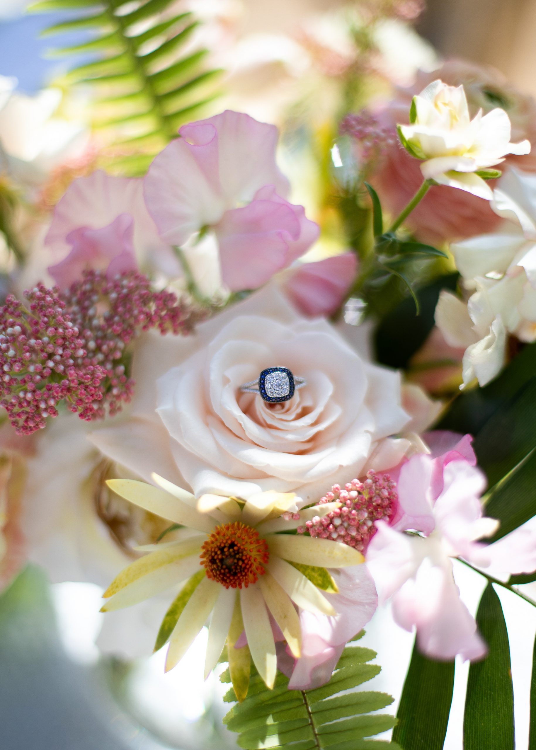 Wedding ring details in tropical bridal bouquet.