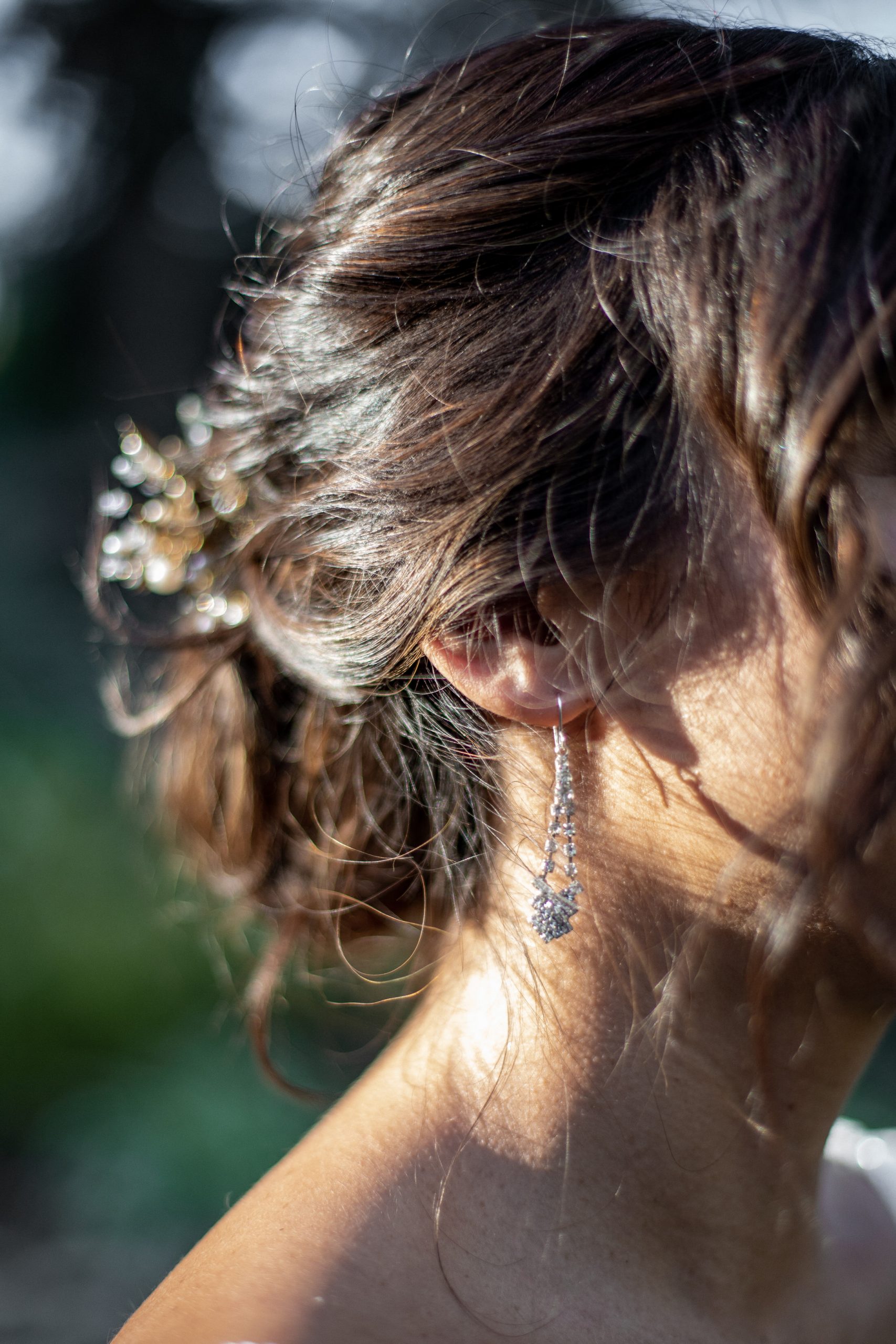 Detaisl of a brides hair and jewelry.