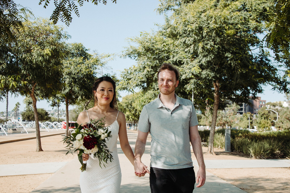 A bride and groom walking.