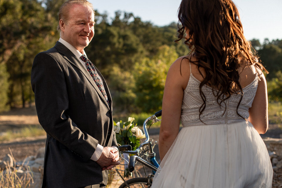 Bride and father of the bride standing with a blue tandem schwinn bike