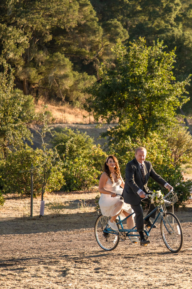 Bride and father of the bride standing with a blue tandem schwinn bike