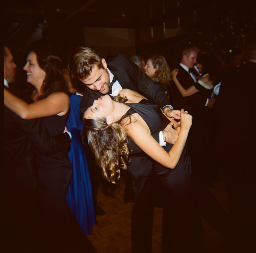 Guest dipping dance partner on reception dance floor at Del Mar Country Club.