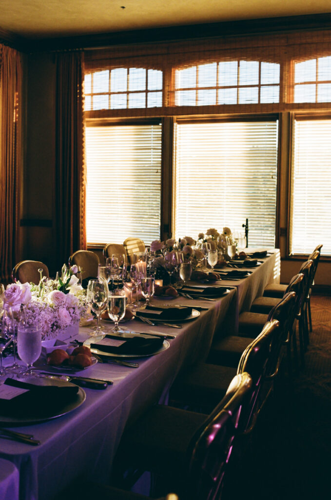 Elegant reception table setup with florals and candles at Del Mar Country Club.