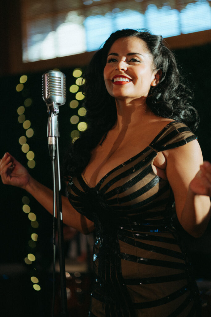 Wedding singer performing with vintage microphone at Del Mar Country Club reception.