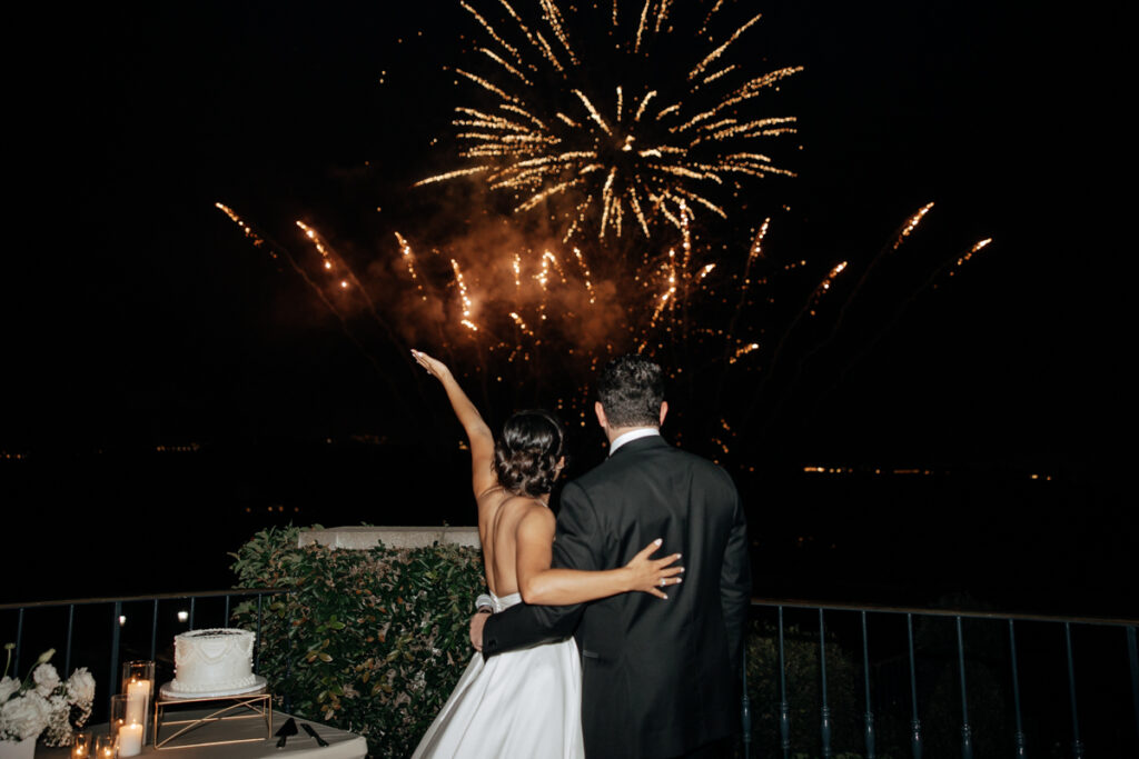 Bride and groom watching fireworks display during Del Mar Country Club wedding reception.