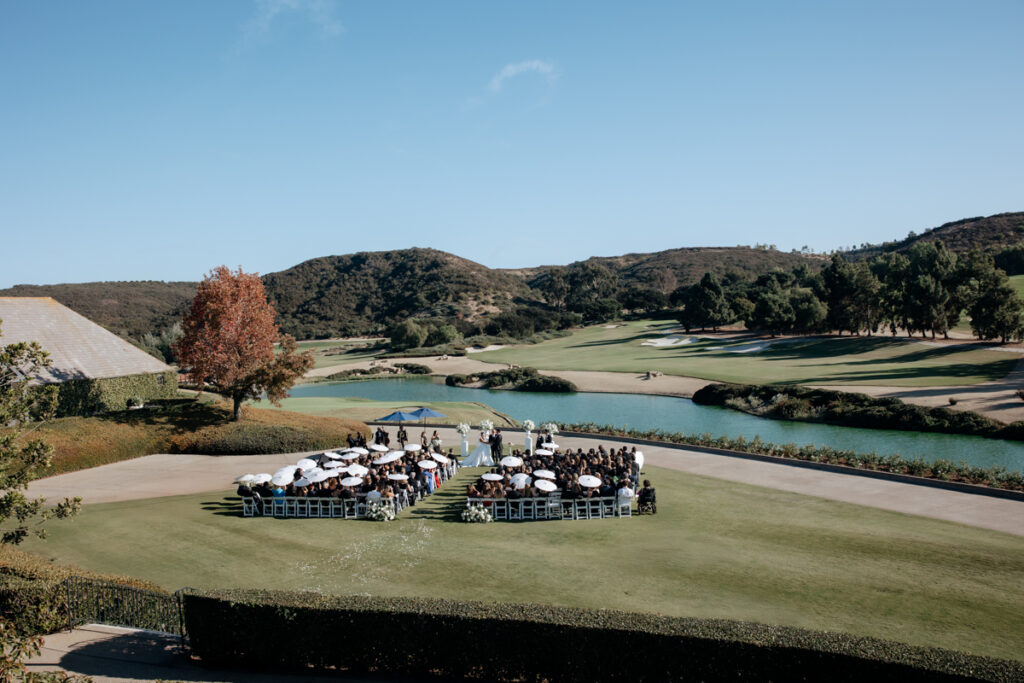 Aerial view of wedding ceremony setup on golf course lawn at Del Mar Country Club.