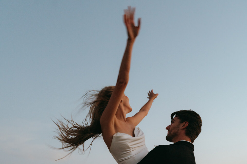Artistic blurred portrait of bride and groom gazing at each other during desert session
